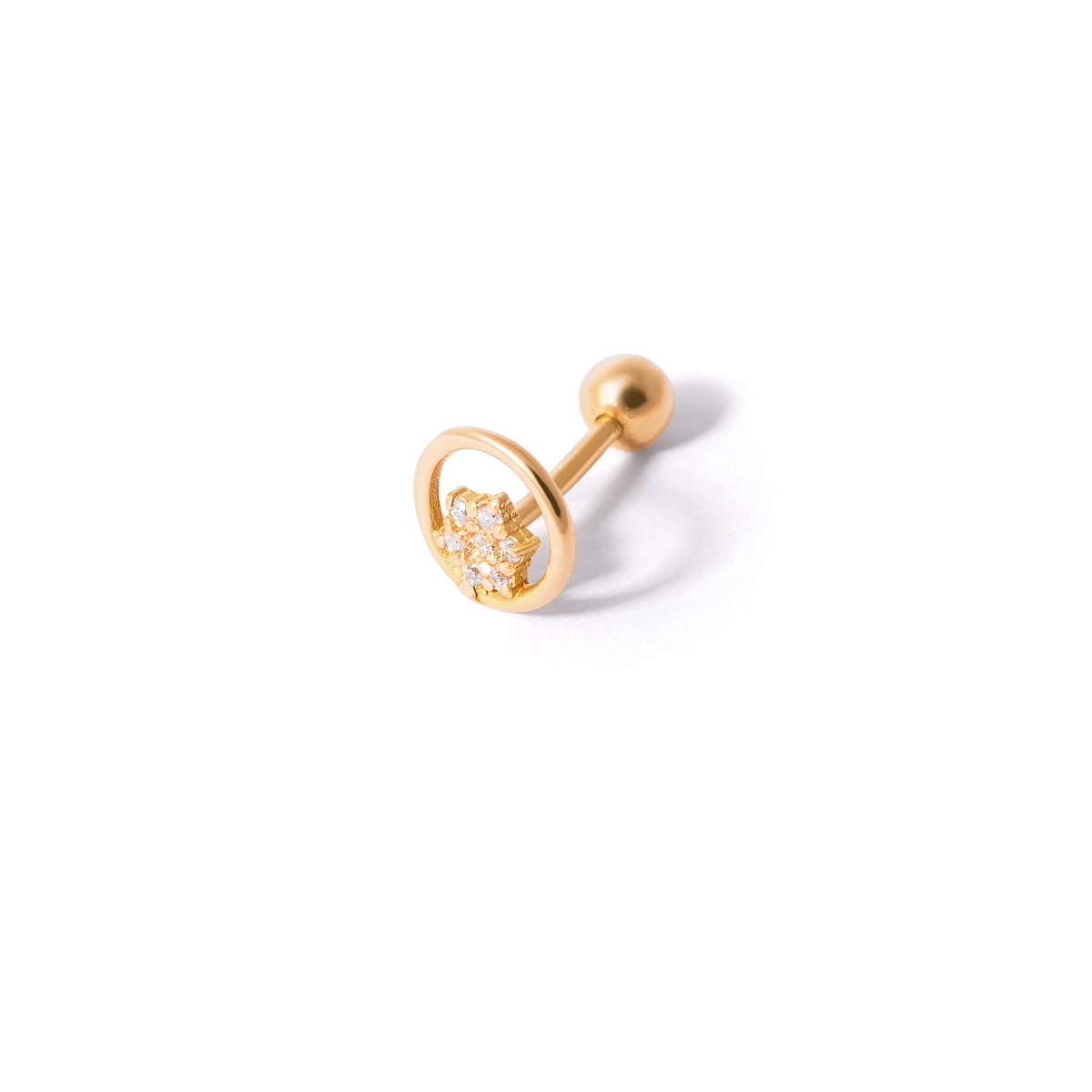 Gold piercing with jeweled flower and circle g